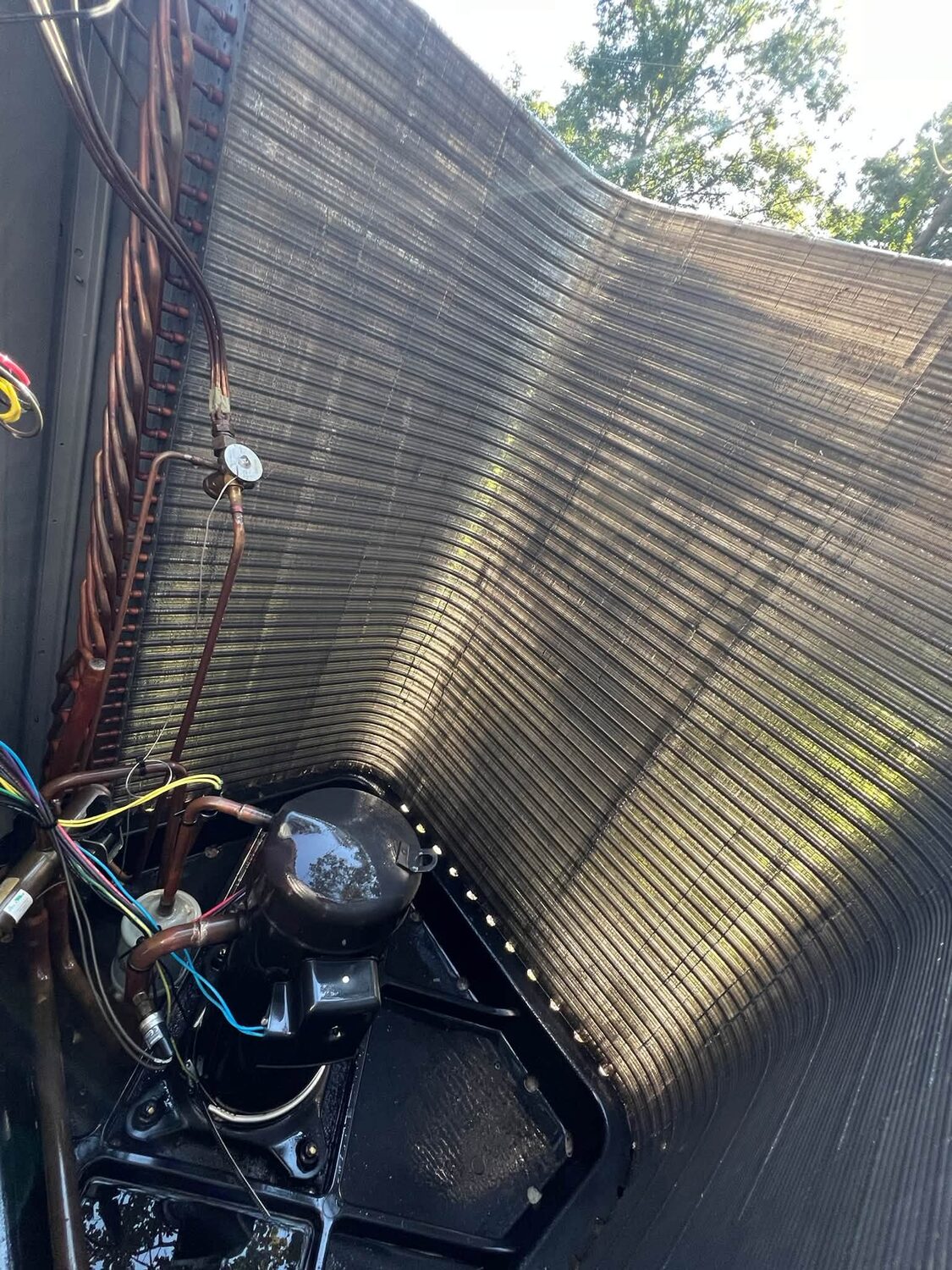 Clean AC condenser coil on a new pad after an Elite Air tune-up